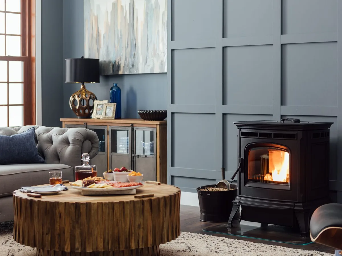 Harman Absolute63 pellet stove in a blue-panelled room with a leather chair