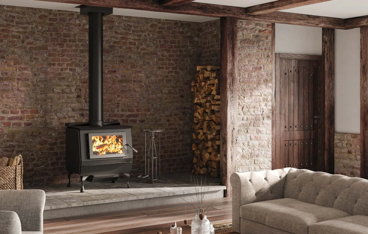 A Blaze King King 40 wood stove burning in a brick-walled living room